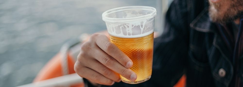 Man drinking a beer considers if alcohol consumption could contribute to or impact his atrial fibrillation 