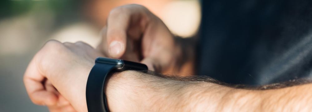 man checking heart rate on his wearable ekg on his wrist